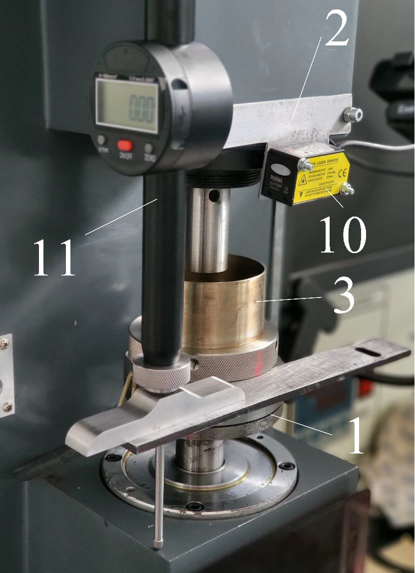 Tribological test rig with digital indicator, laser displacement sensor, and bronze specimen at the friction interface